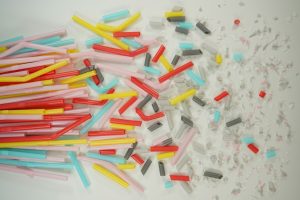Microscopic plastic particles suspended in water, illustrating the invisible threat of microplastic pollution.