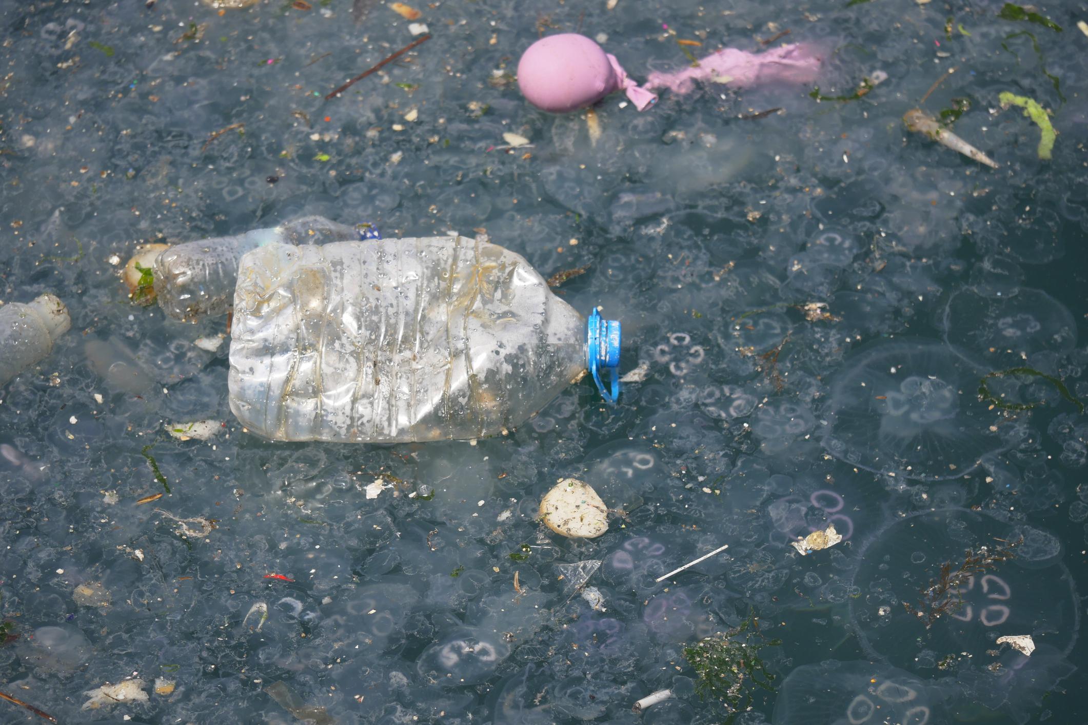 “World leaders discussing environmental policy with plastic waste and ocean imagery in the background.”
