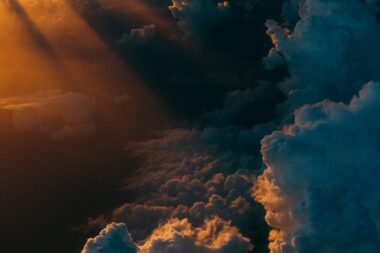 Dramatic storm clouds lit by sunlight, illustrating Europe's rising climate risk
