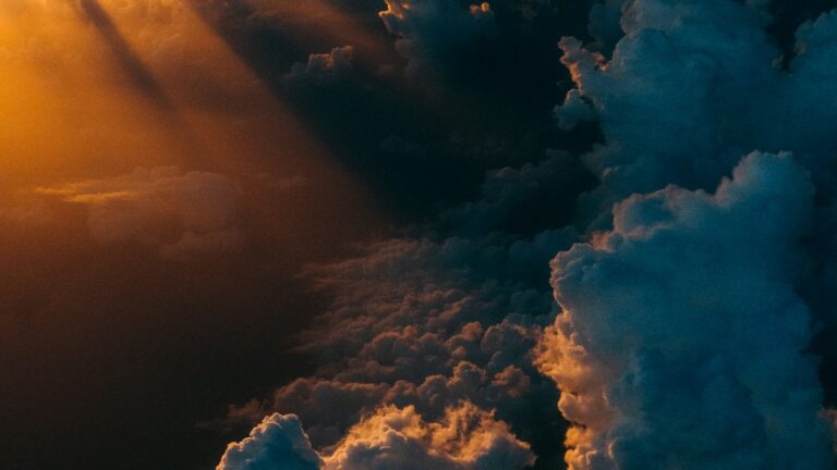 Dramatic storm clouds lit by sunlight, illustrating Europe's rising climate risk