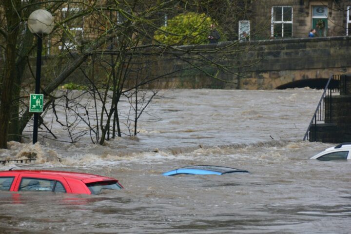 Floodwater submerging cars on a flooded street