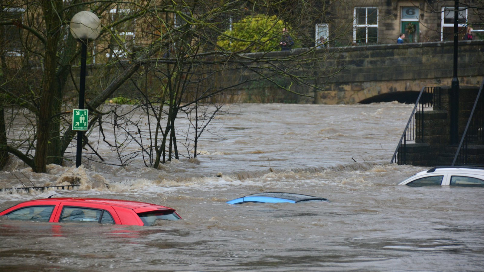 Floodwater submerging cars on a flooded street
