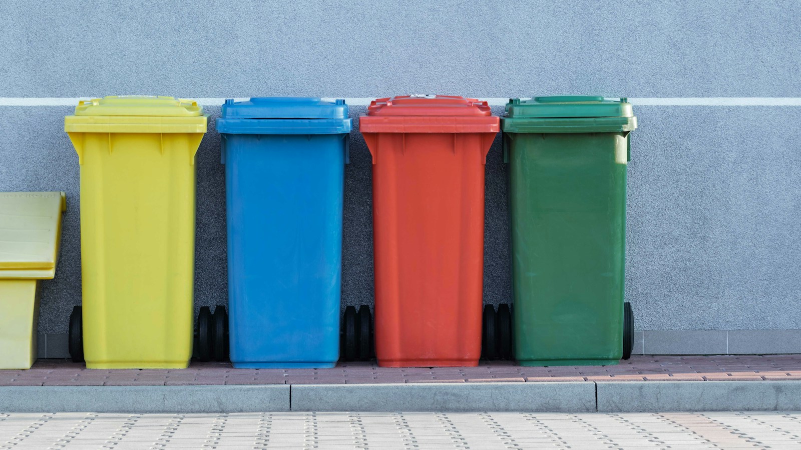 Yellow, blue, red and green recycling bins